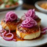 Finished dish with cebolla morada encurtida, enhancing the presentation of various meals.