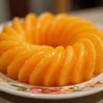 Finished piel de naranja confitada presented on a plate, perfect for sweet treats.