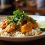 Delicious pollo al curry con arroz served on a plate, perfect for any meal.
