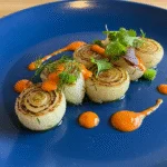 Finished dish featuring cebolla tierna, a refreshing touch adding flavor and elegance to the meal.