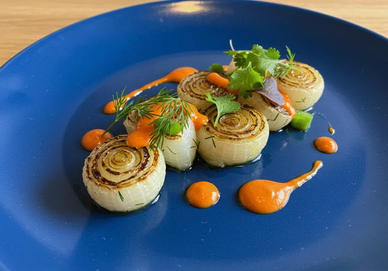 Finished dish featuring cebolla tierna, a refreshing touch adding flavor and elegance to the meal.